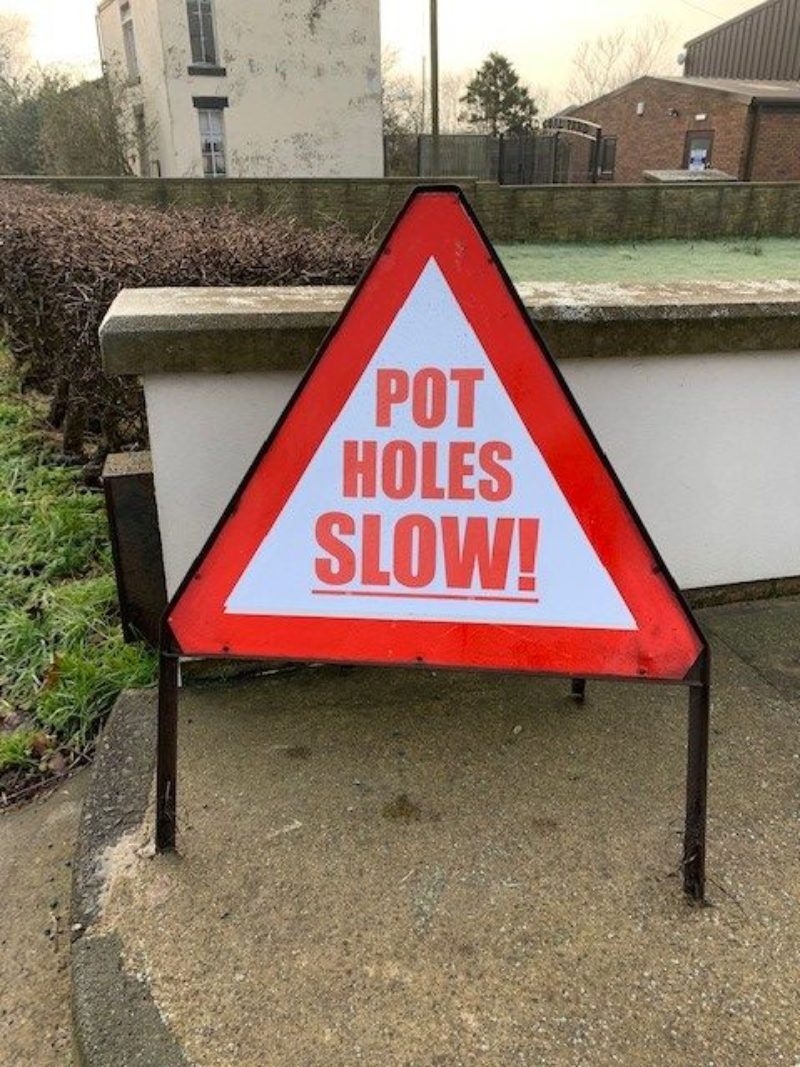 Residents create their own signs to warn drivers